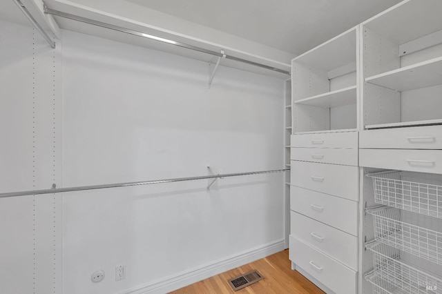 spacious closet featuring light hardwood / wood-style flooring