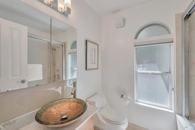 bathroom with vanity, toilet, and an enclosed shower