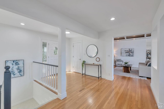 corridor with light hardwood / wood-style floors