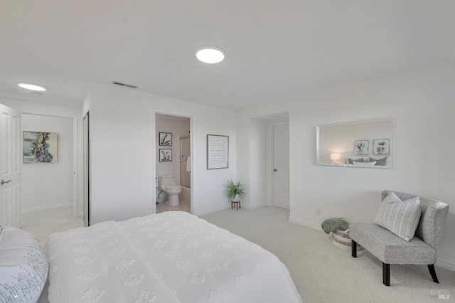 carpeted bedroom featuring connected bathroom