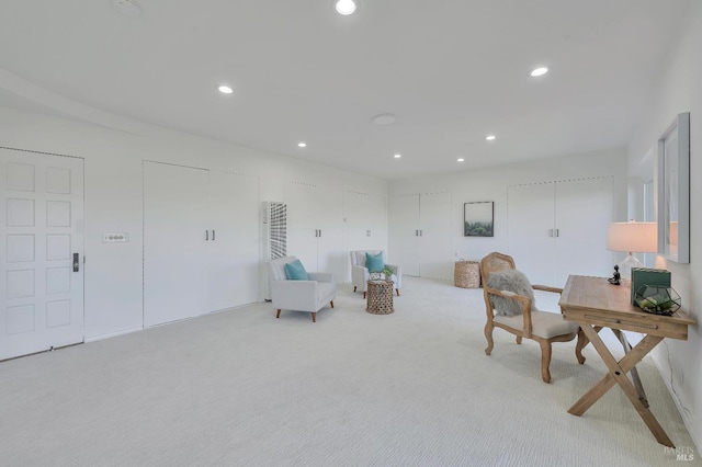 sitting room featuring light carpet