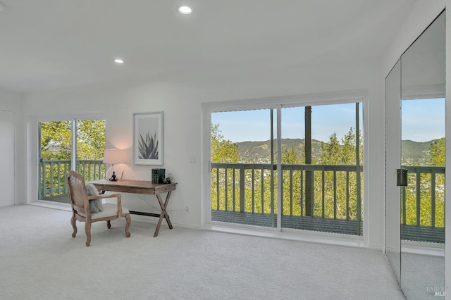 sunroom / solarium featuring a mountain view