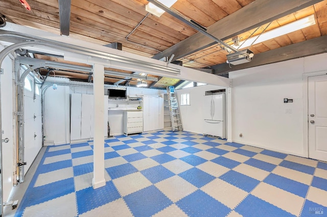 basement featuring wood ceiling and white fridge