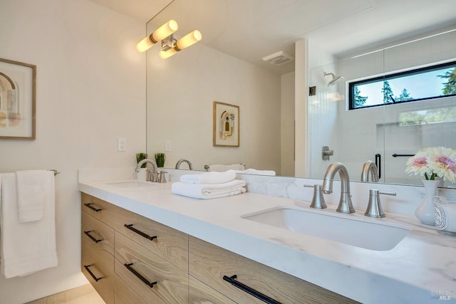 bathroom featuring walk in shower, a sink, visible vents, and double vanity