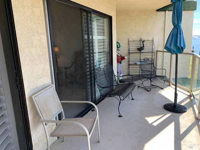 view of patio featuring a balcony