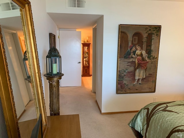 bedroom featuring visible vents, light carpet, and baseboards