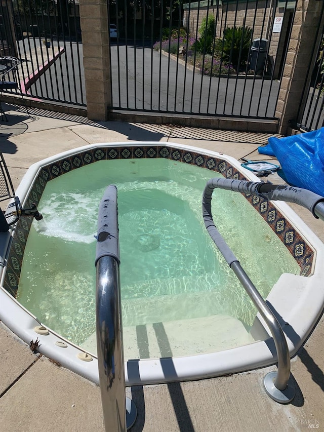 view of swimming pool with a community hot tub