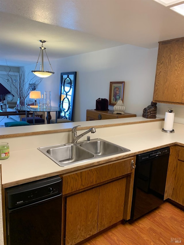 kitchen with a sink, light countertops, and dishwasher