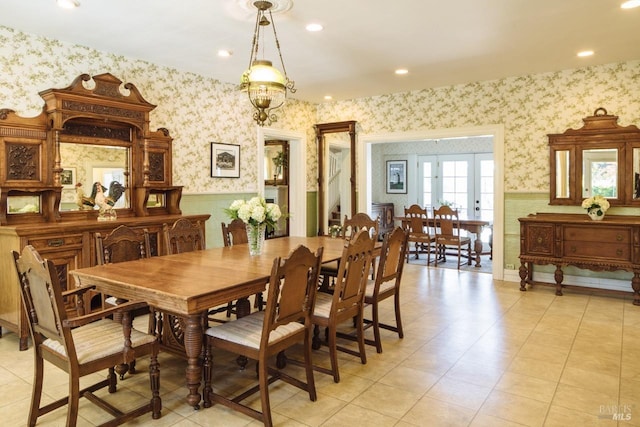 dining space with french doors and a chandelier