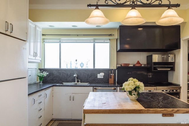 kitchen with white refrigerator, white cabinetry, sink, tasteful backsplash, and stainless steel dishwasher