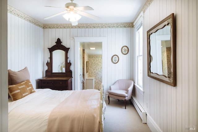 bedroom with carpet flooring, baseboard heating, ensuite bathroom, and ceiling fan