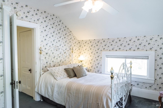 carpeted bedroom with ceiling fan and vaulted ceiling