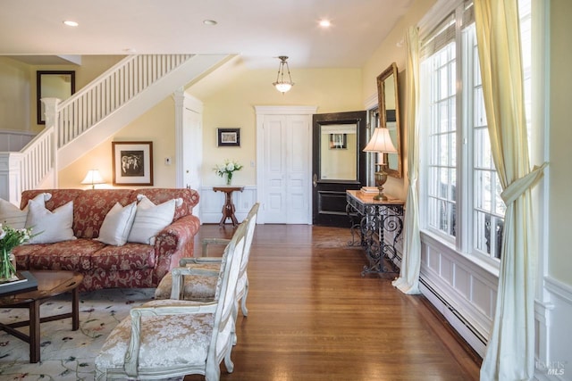 interior space with a baseboard radiator and dark hardwood / wood-style floors