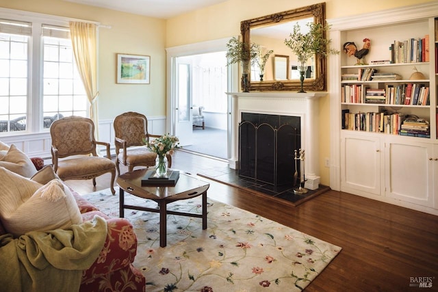 living room with dark wood-type flooring and plenty of natural light