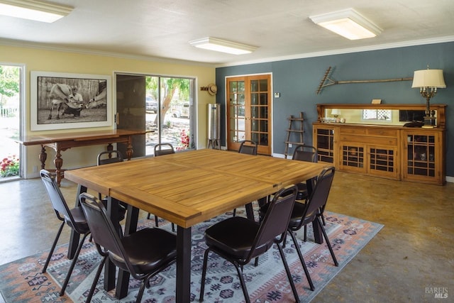 dining room with concrete floors and ornamental molding