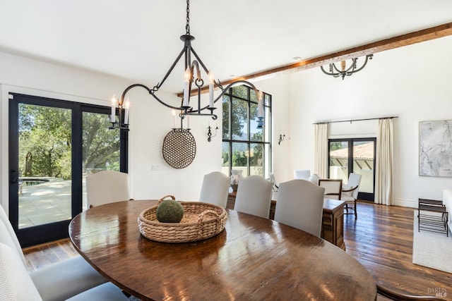 dining space with a notable chandelier and wood finished floors