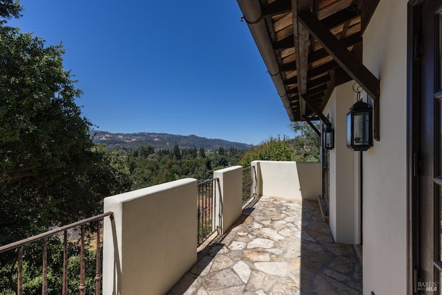 balcony with a mountain view and a view of trees