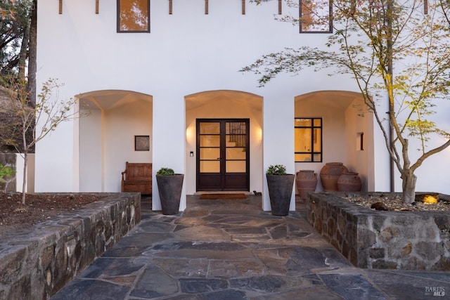 doorway to property with stucco siding