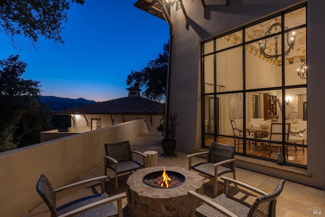 balcony featuring a fire pit and a patio