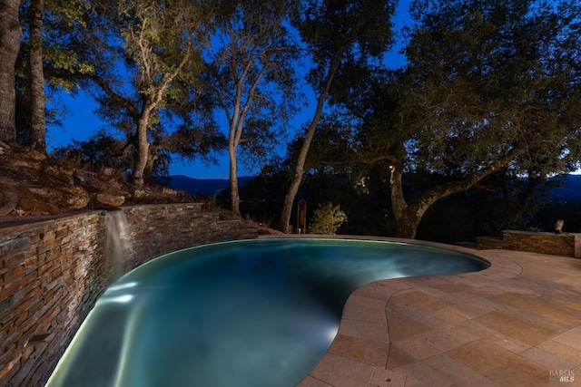 outdoor pool with a patio area