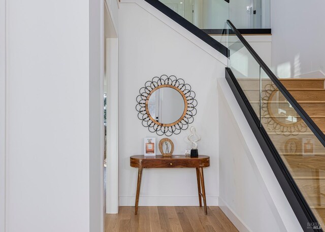 staircase with hardwood / wood-style floors