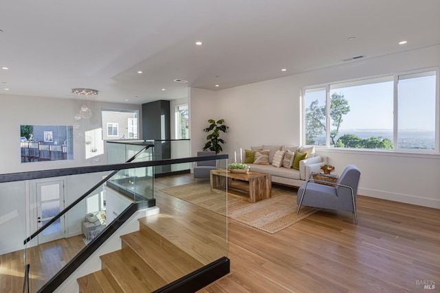 living room with hardwood / wood-style flooring and a healthy amount of sunlight