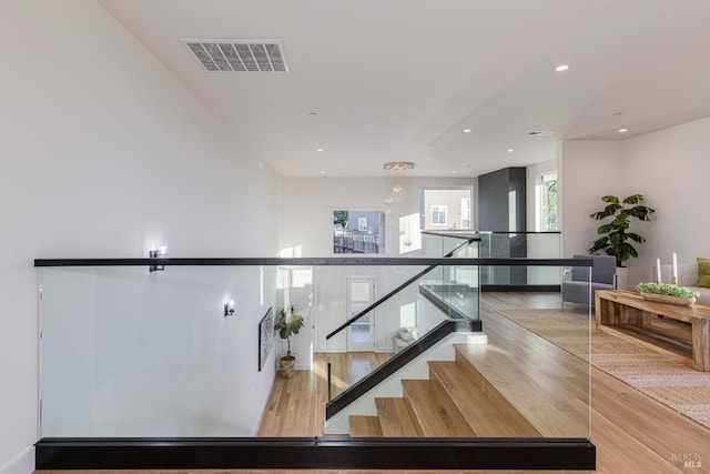 stairs featuring hardwood / wood-style flooring