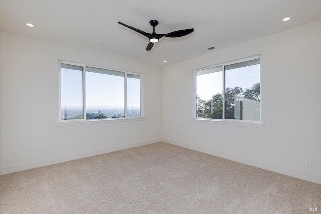 carpeted empty room with ceiling fan