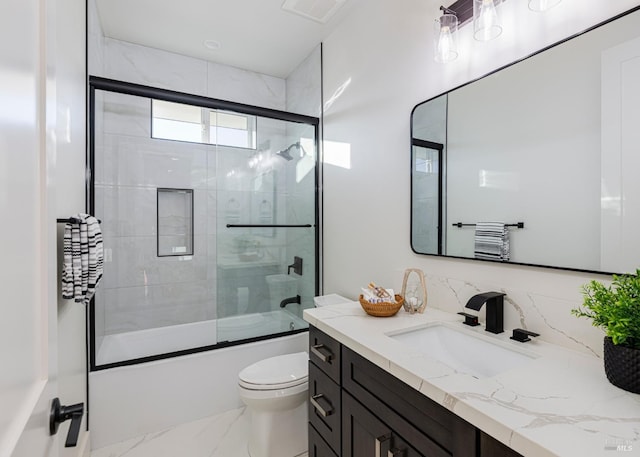 full bathroom featuring vanity, shower / bath combination with glass door, and toilet