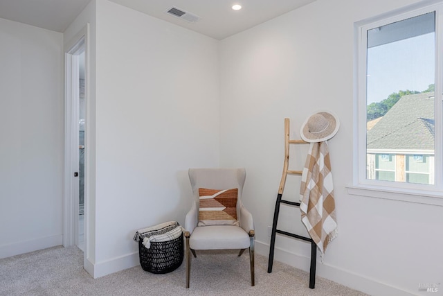 sitting room featuring light colored carpet