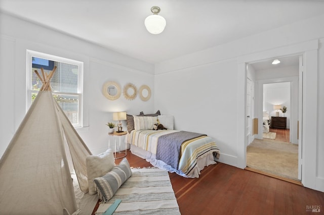 bedroom with dark hardwood / wood-style flooring