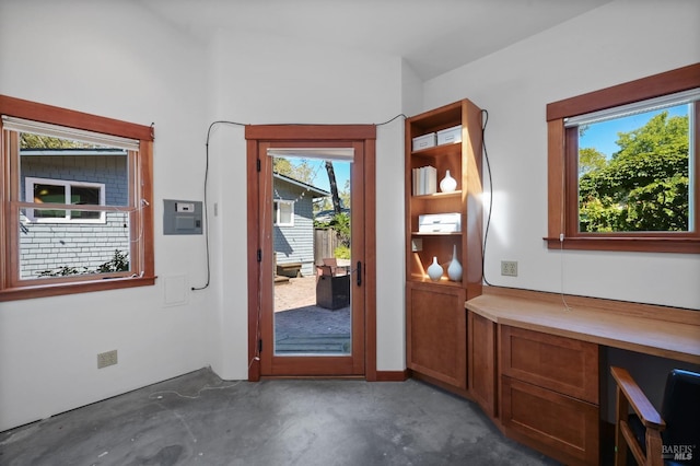 entryway with concrete flooring and electric panel