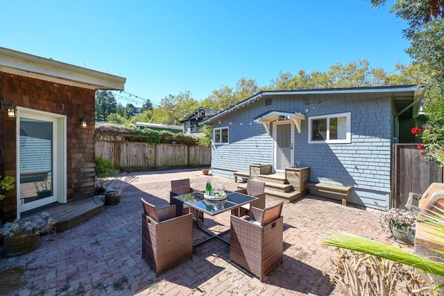 view of patio / terrace with outdoor dining space and fence