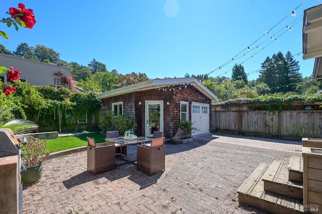 view of patio / terrace with outdoor dining area, an outdoor structure, and fence