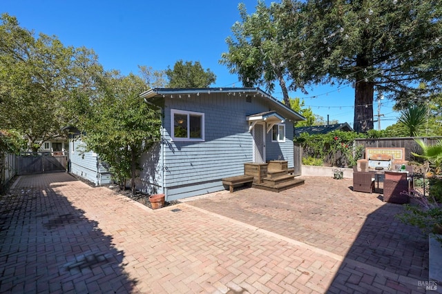 back of house with outdoor lounge area and a patio