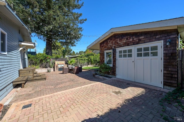 view of patio with an outdoor structure and fence