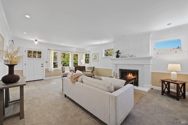 carpeted living room featuring a fireplace and ornamental molding