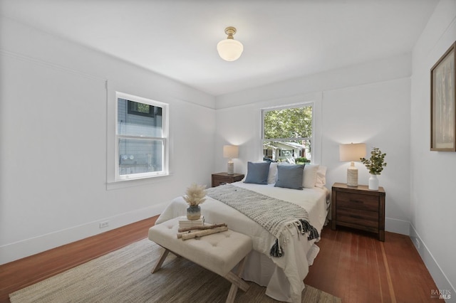 bedroom with baseboards and wood finished floors