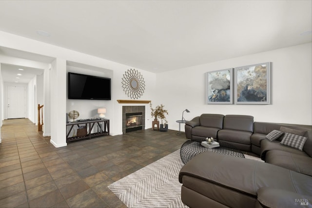 living room with a tile fireplace