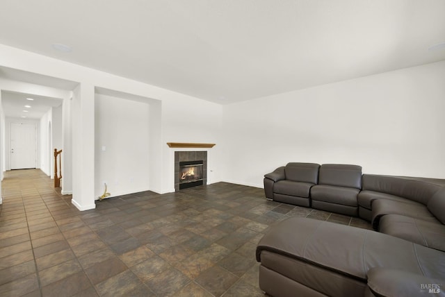 living room with a tiled fireplace