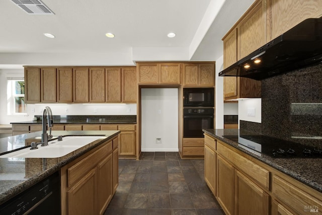 kitchen featuring ventilation hood, black appliances, dark stone countertops, and sink