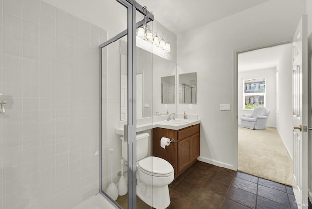 bathroom featuring a shower with door, vanity, and toilet