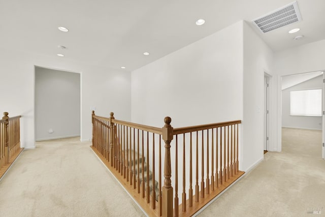 corridor with light colored carpet