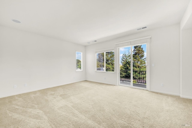 spare room with light colored carpet