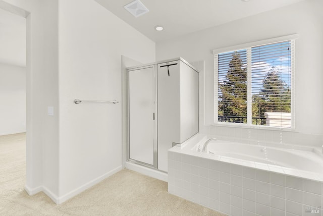 bathroom featuring separate shower and tub