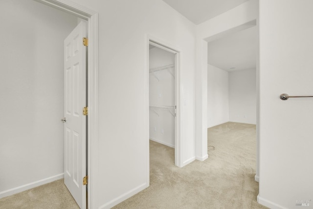 hall featuring light colored carpet