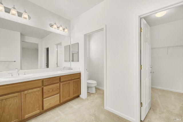 bathroom featuring toilet and vanity