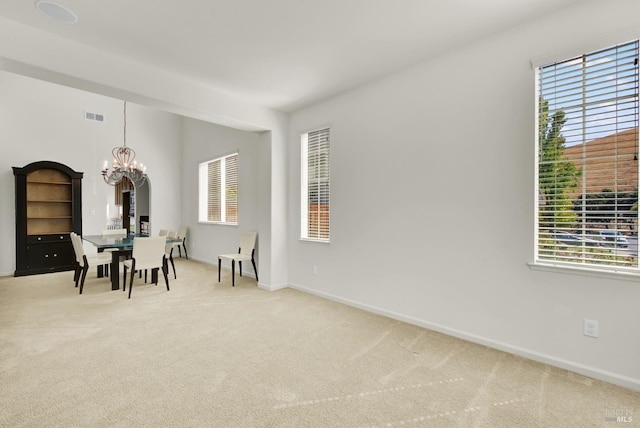 interior space with light carpet and a chandelier