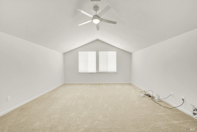 additional living space featuring vaulted ceiling, ceiling fan, and carpet floors