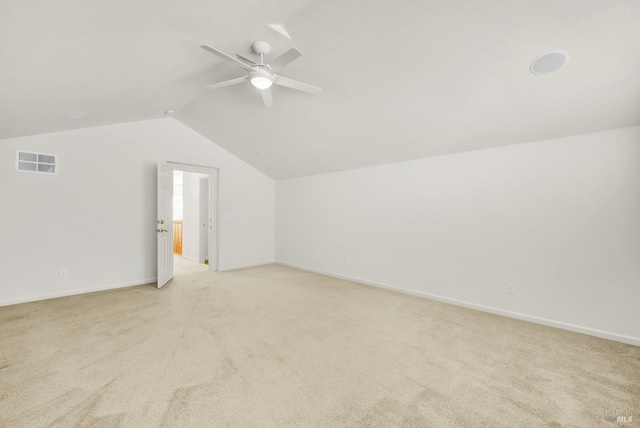 additional living space with ceiling fan, light carpet, and vaulted ceiling